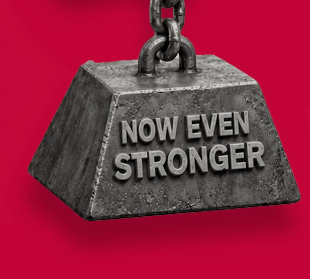 Steel weight hanging from a chain stamped Now Even Stronger
